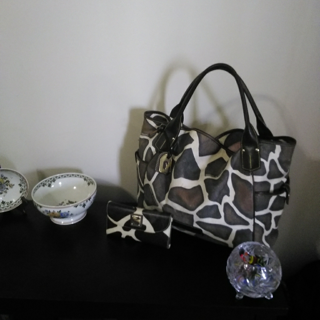 Used Dooney & Bourne Giraffe Print Handbag.